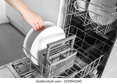  Loading dishes. Dishwashing capsules. Open dishwasher with clean dishes in the white kitchen. Opening and closing the dishwasher.