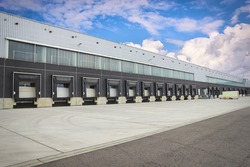 Loading dock cargo doors at big warehouse, an Industrial Photo by portumen
