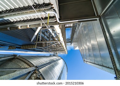 Loading facility building exterior. Low angle view of the tanks and agricultural silos of grain elevator storage. View from below.