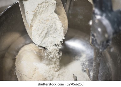 Loading Flour Into An Industrial Bakery Dough Mixer. Close Up View.