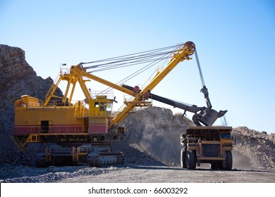 Loading The Gold Ore Into Heavy Dump Truck At The Opencast Mining