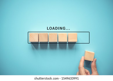 Loading, hand putting wood cube in progress bar. - Shutterstock ID 1549633991