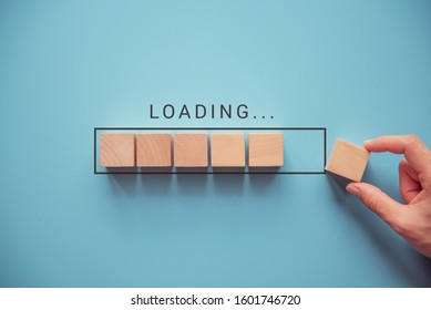 Loading, hand putting wood cube in progress bar. - Shutterstock ID 1601746720
