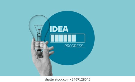 Loading idea business concept and progress. Idea loading concept with light bulb on blue background. Creativity for business idea and problem solving. Brainstorm in progress