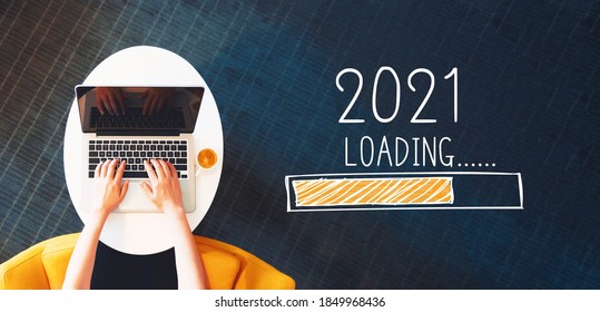 Loading new year 2021 with person using a laptop on a white table