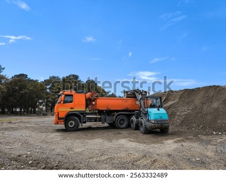 Loading operation with a wheel loader loading a truckload of gravel at a landfill site