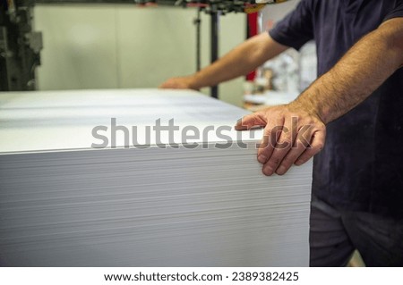 Loading paper onto an offset printing machine operation
