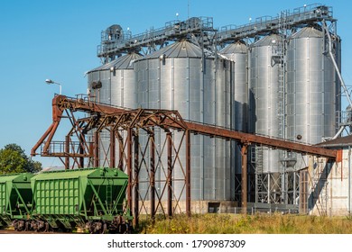 Loading railway wagon standing near the elevator in agriculture zone. Grain silo, warehouse or depository is an important part of harvesting