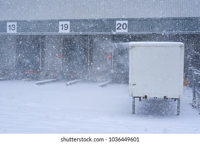 Loading Ramp Doors At Distribution Center During Heavy Snow Condition.