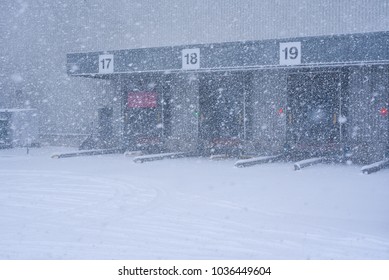 Loading Ramp Doors At Distribution Center During Heavy Snow Condition.