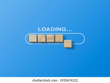 Loading, reboot, refresh or mindset concept. Wooden blocks are arranged in progress bar on blue background with the word uploading.