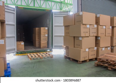 loading shipment carton boxes and goods on wooden pallet at loading dock from container - Shutterstock ID 1803896887