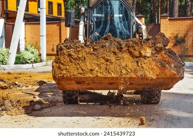 Loading soil with an excavator at a new construction site.
Backhoe Digging at Construction Site. - Powered by Shutterstock