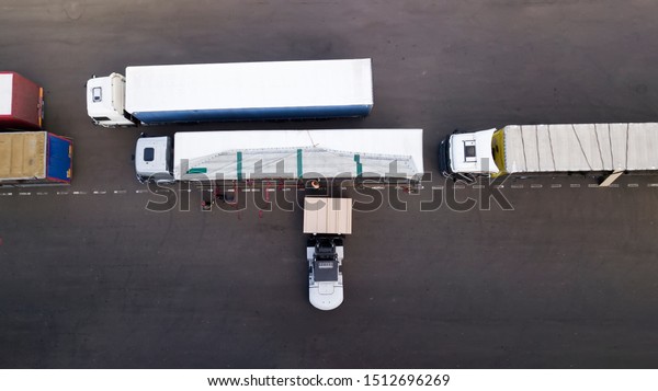 loading a truck in\
a logistics center top\
view