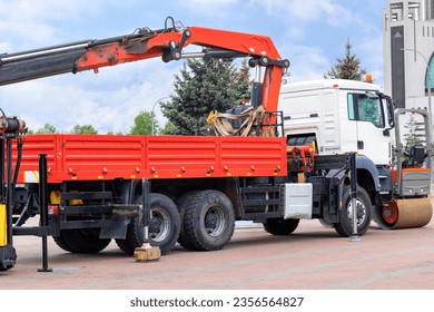 Loading and unloading machine of red color stands in the transport parking of the construction exhibition.