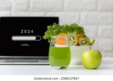 Loading year 2024 for start new business and new life. Healthy  fresh healthy salad and vegetable green water for diet with working in office
