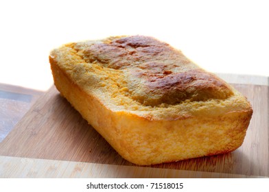 Loaf Of Baked Cornbread On Wooden Platter