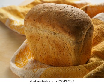loaf of black bread on a table.