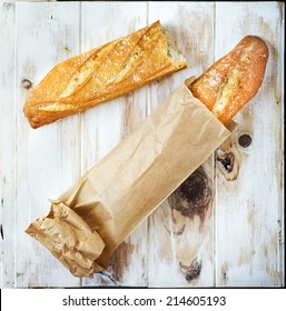 Loaf Of Bread In A Grocey Paper Bag (european Style) On A Rustic Table.