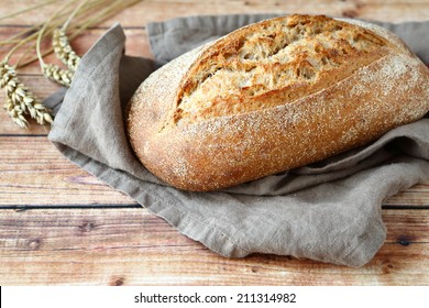 loaf of bread on wooden background, food closeup - Shutterstock ID 211314982
