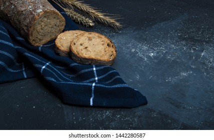 A loaf of fresh bread made from rye flour. Bread cut into slices.