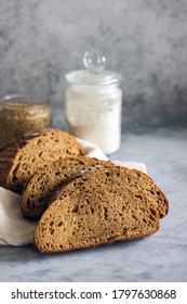 Loaf of sliced sourdough bread on a dark background, Close-up. Handmade Whole Grain Dark Bread - Shutterstock ID 1797630868