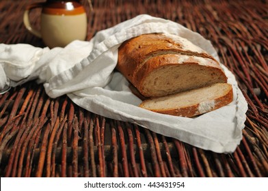 Loaf and slices of bread on a white cloth - Shutterstock ID 443431954