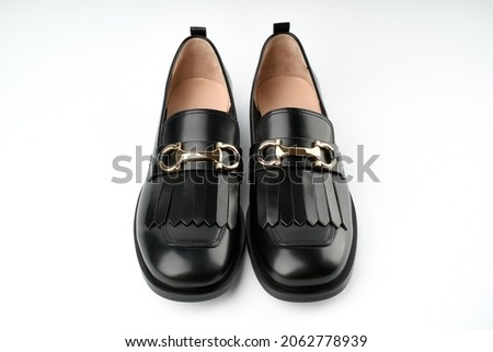 Loafers isolated on white background. Pair of Stylish Expensive Modern Leather Black Loafers Shoes. Fashion concept with woman shoes on white.