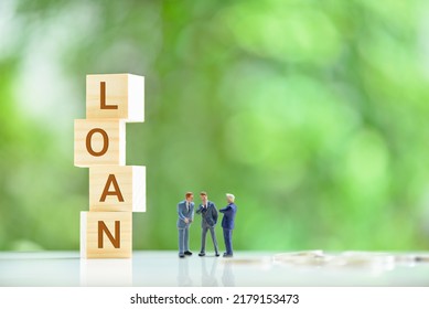 Loan agreement between a lender and borrowers, financial concept : Miniature businessmen negotiate loan terms and discuss about the company's credit and loan profile. CFO confer on repayment terms.