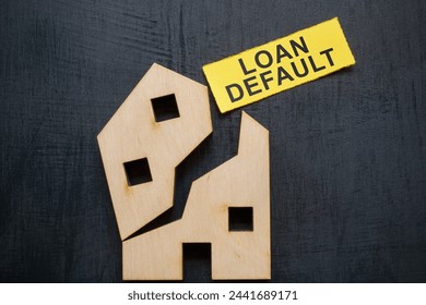 Loan default concept. Broken model of a house and a piece of paper.