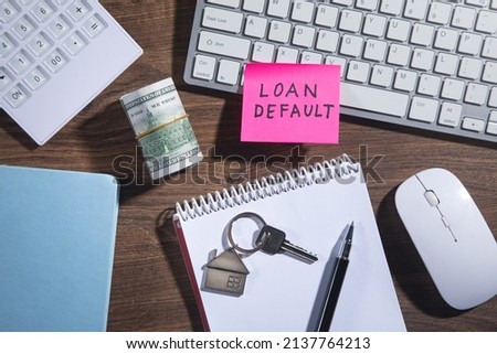 Loan Default on sticky note with a business objects.