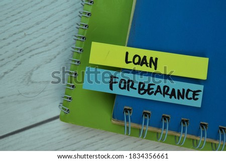 Loan Forbearance write on sticky notes isolated on office desk. Selective focus on Loan Forbearance