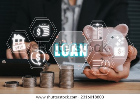 Loan or lending cash to buy asset concept, Business woman hand holding piggy bank with Loan or lending cash icon on virtual screen.