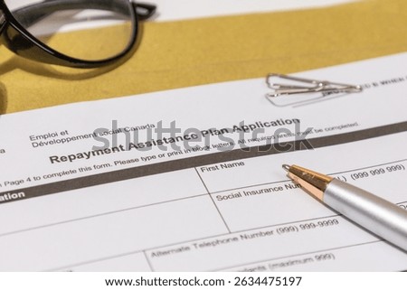 Loan Support Application Form on Tabletop – Structured Repayment Plan in Professional Setting