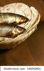 Loaves Of Bread And Two Fishes In A Basket