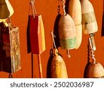 Lobster buoys hanging on red wall, Bar Harbor, Maine