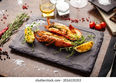 Lobster with flavored butter. Herb butter, lemon. Delicious healthy traditional food closeup served for lunch in modern gourmet cuisine restaurant.