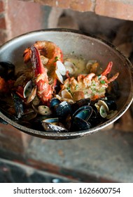 Lobster, Mussels, Clams And Shrimp. Classic Italian Restaurant Entree Favorite. Seafood Stew Baked In Wood Fire Over And Severed With Olive Oil, Lemons And Garnished With Italian Parsley.
