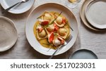 Lobster Ravioli: Delicate pasta pockets filled with sweet lobster meat, served in a luxurious butter sauce with a hint of lemon and fresh herbs for a refined touch.