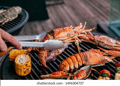 Lobster, Rock Lobster And Mix Seafood Barbecue Cokking On Grill - Seafood Dinner Party Concept