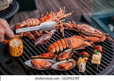 Lobster, Rock Lobster And Mix Seafood Barbecue Cokking On Grill - Seafood Dinner Party Concept