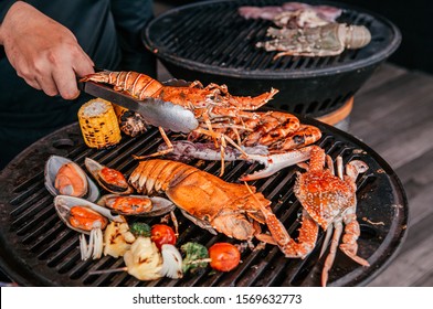 Lobster, Rock Lobster And Mix Seafood Barbecue Cokking On Grill - Seafood Dinner Party Concept