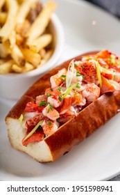 Lobster Roll Served With Fries And White Wine For Lunch Or Dinner