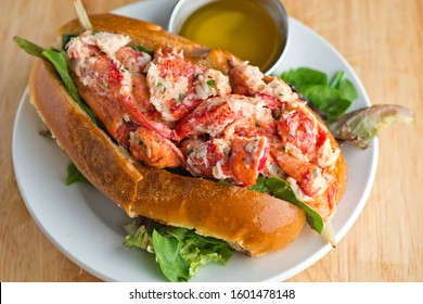 Lobster Roll. Traditional classic American Sandwich. New England classic, fresh Maine Lobster boiled, mixed with mayo, celery, chives served in toasted hero roll with crisp lettuce and drawn butter.