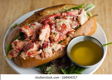 Lobster Roll. Traditional classic American Sandwich. New England classic, fresh Maine Lobster boiled, mixed with mayo, celery, chives served in toasted hero roll with crisp lettuce and drawn butter.