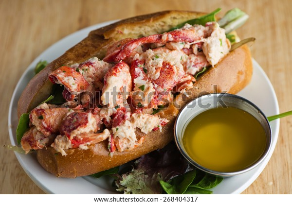 Lobster Roll. Traditional classic American
Sandwich. New England classic, fresh Maine Lobster boiled, mixed
with mayo, celery, chives served in toasted hero roll with crisp
lettuce and drawn
butter.