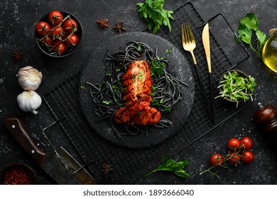 Lobster Tail Baked In Garlic Sauce And Black Pasta With Cuttlefish Ink. Luxury Restaurant Food. Seafood. Rustic Style. Flat Lay.