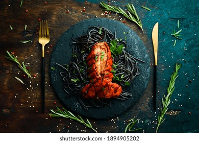 Lobster Tail Baked In Garlic Sauce And Black Pasta With Cuttlefish Ink. Luxury Restaurant Food. Seafood. Rustic Style. Flat Lay.