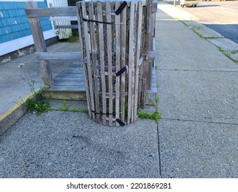 A Lobster Trap Standing Upright In The Middle Of A Sidewalk.