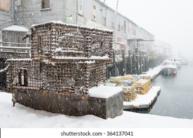 Lobster traps on a pier during a snowstorm in Maine
